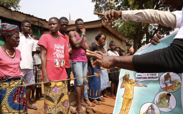 UNICEF coordinators and volunteers using illustrations to help educate people about the Ebola outbreak. Credit: World Bank.